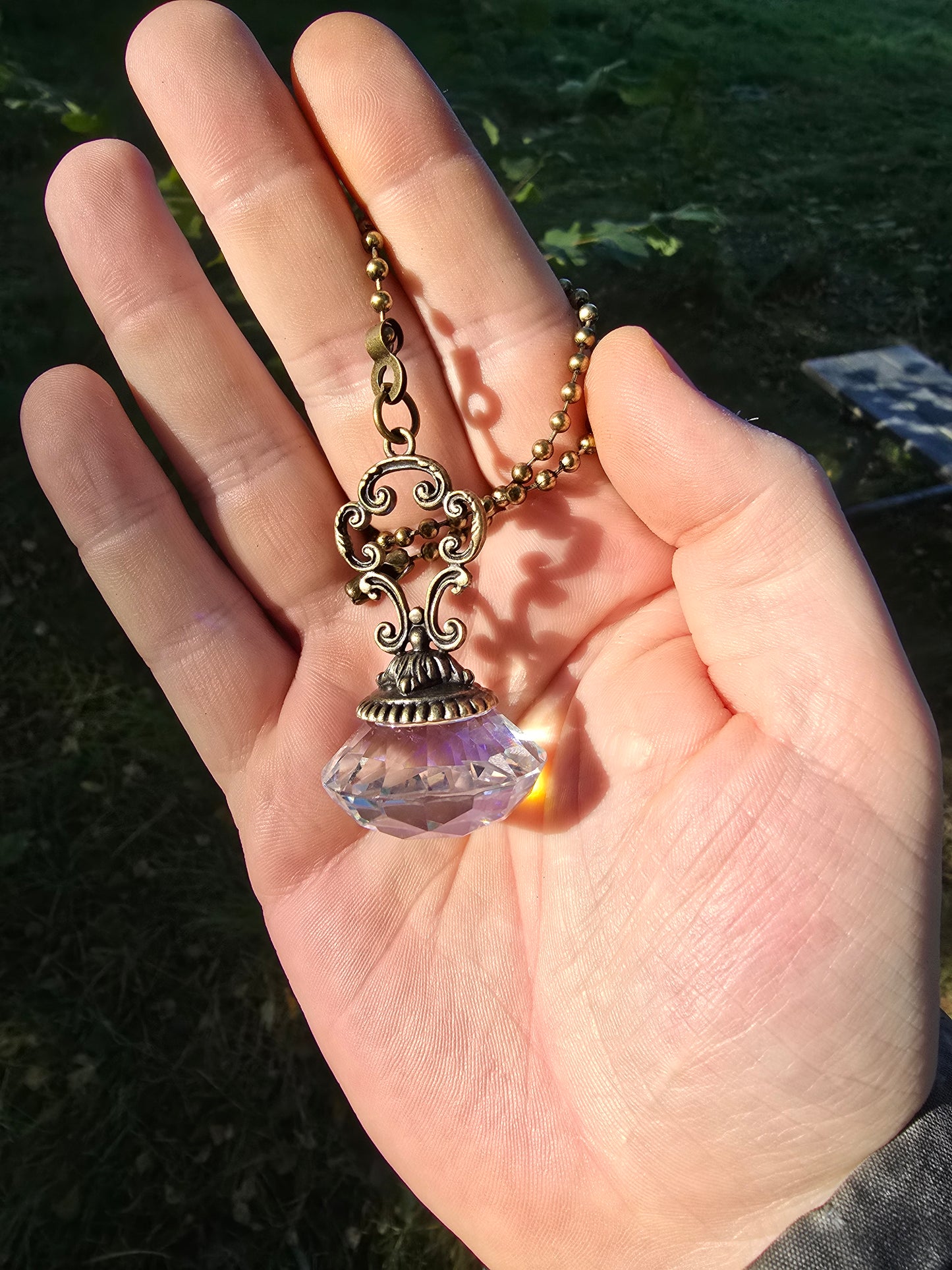 Suncatcher Pendant with Faceted Crystal and Antique Metal Design