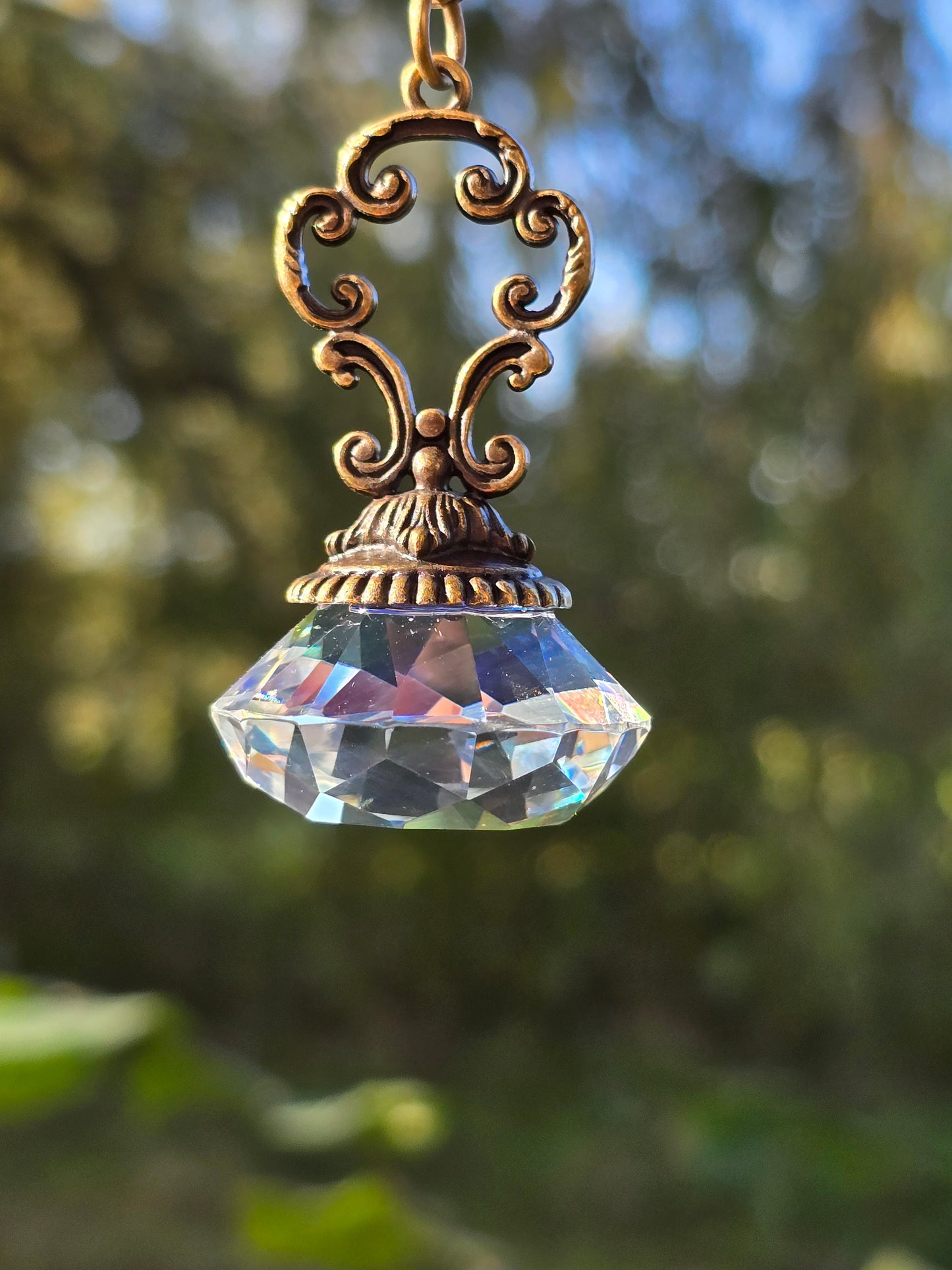 Suncatcher Pendant with Faceted Crystal and Antique Metal Design